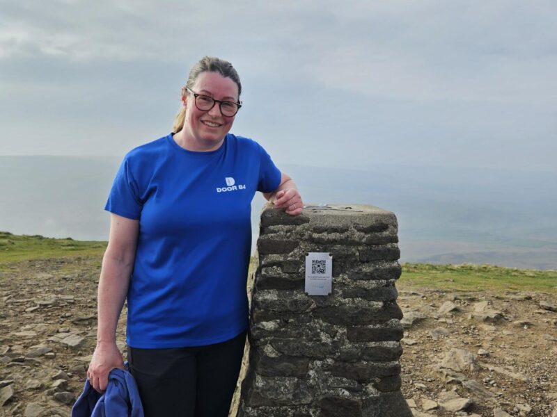 person at the top of a peak