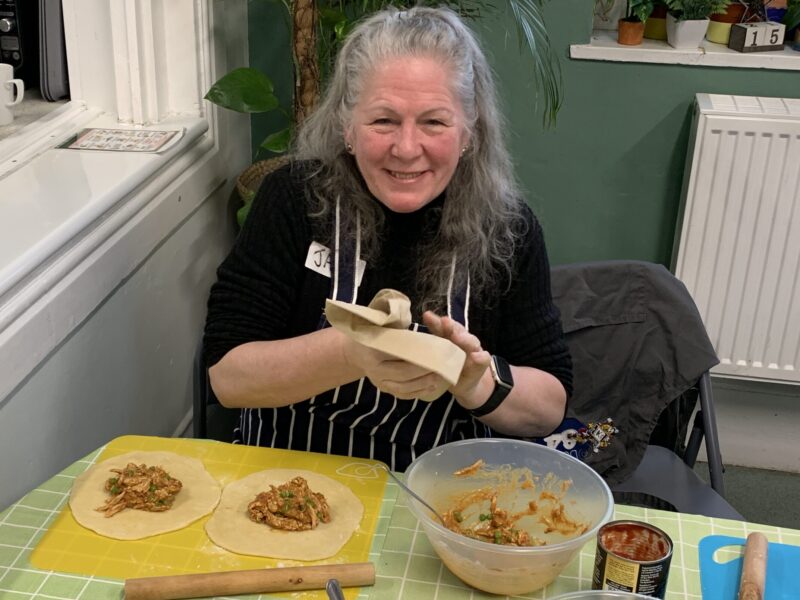 cooking course attendee making wraps