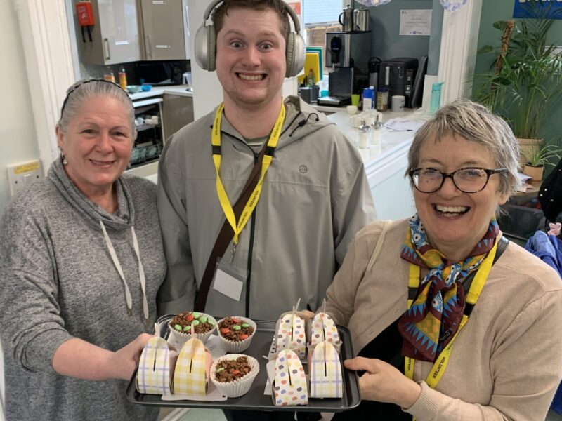 sparks volunteers holding cakes